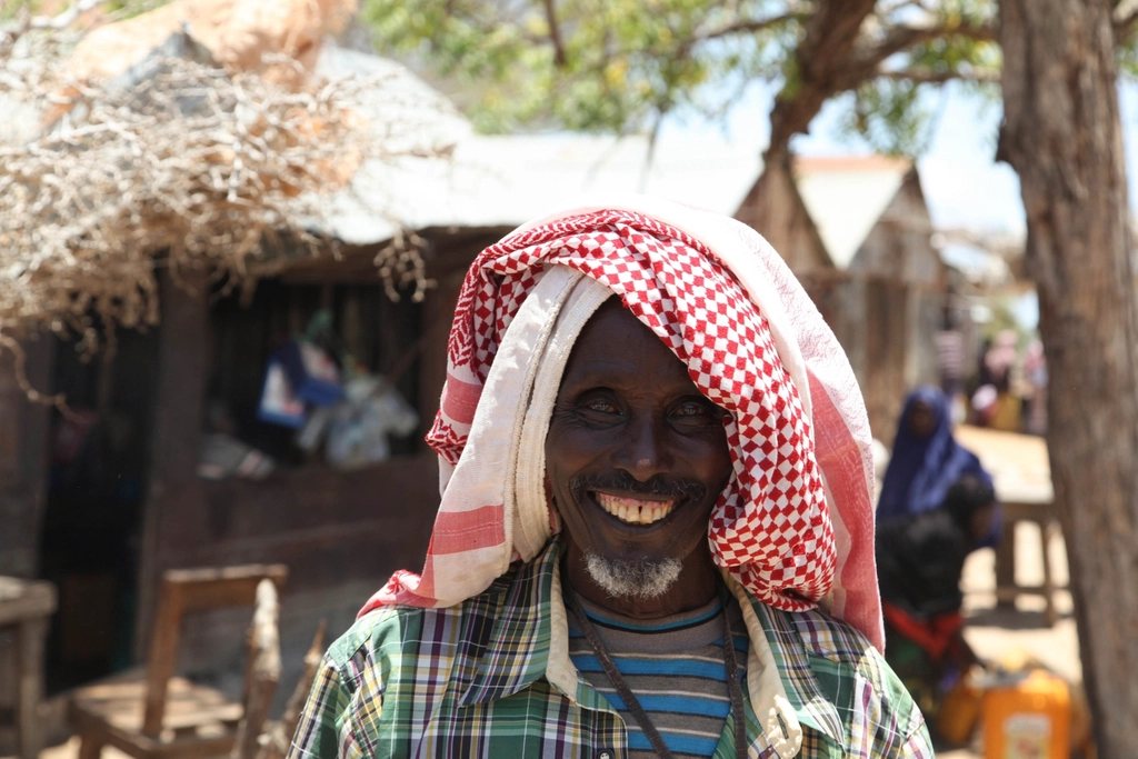 Somali man smiles camera town