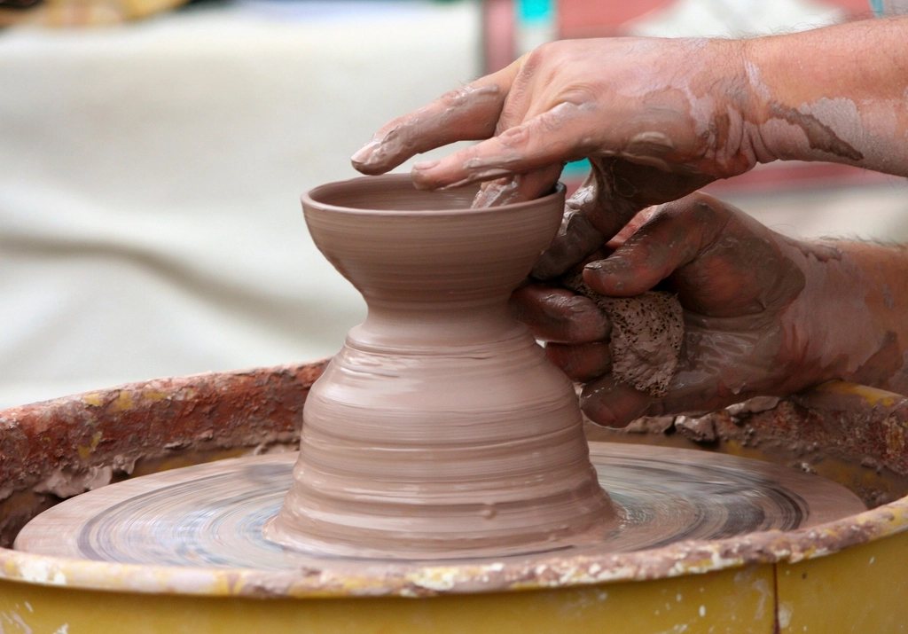 Person making handmade pottery